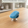 Single oval blue hyaluronic acid soap with leaf design on a silver stand.