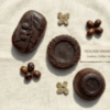 Three different shapes of handmade organic coffee soap with roasted coffee beans.